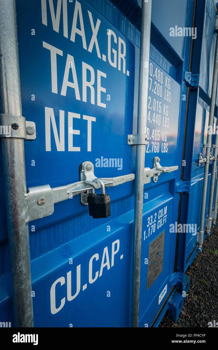 A row of Blue Self Storage Shipping Containers in a secure compound Stock Photo Alamy