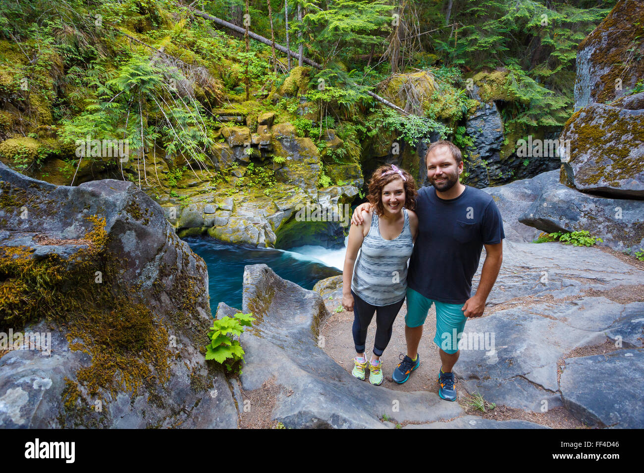 Man and woman exploring the North Umpqua River above Toketee Falls in Oregon. Stock Photo