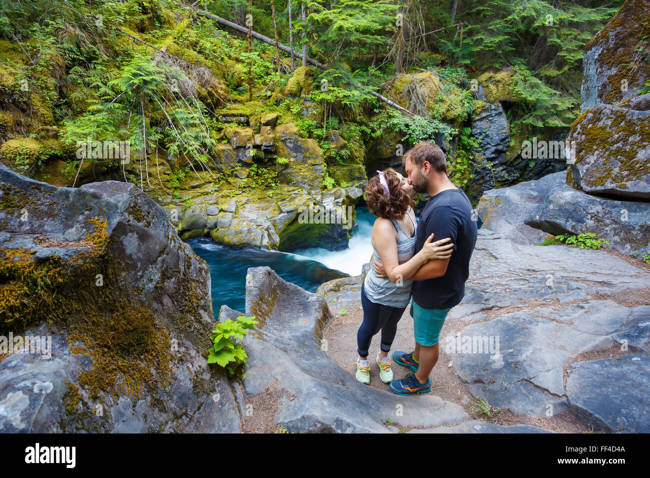 Man and woman exploring the North Umpqua River above Toketee Falls in Oregon. Stock Photo