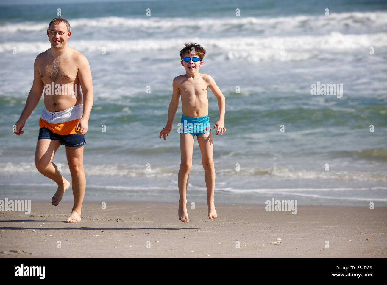 Young father and son playing on the beach Stock Photo