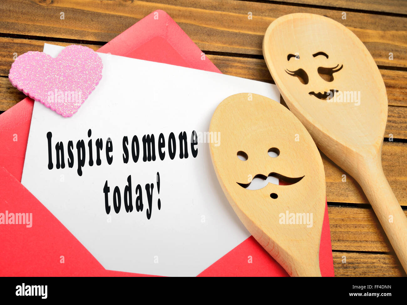 Inspire someone today written on paper Stock Photo