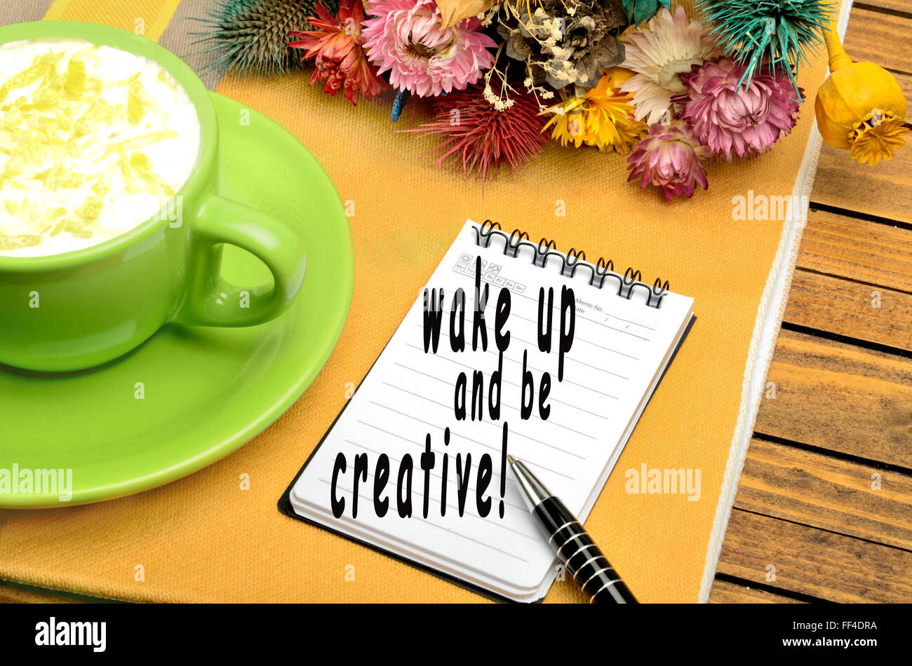 Wake up and be creative written on notebook Stock Photo