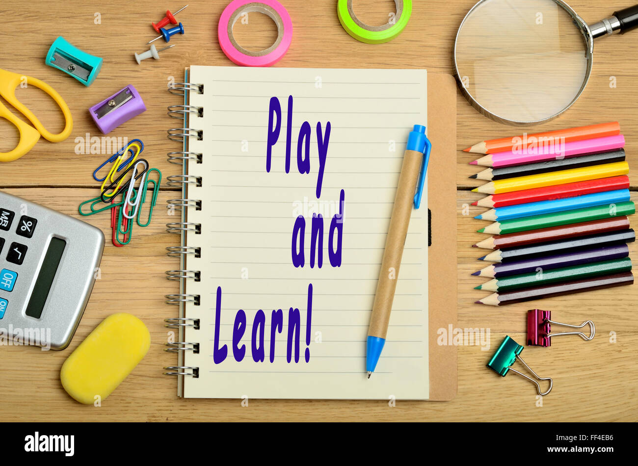 Play and learn text written on notebook Stock Photo