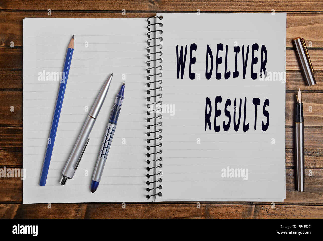 We deliver results text on notebook Stock Photo