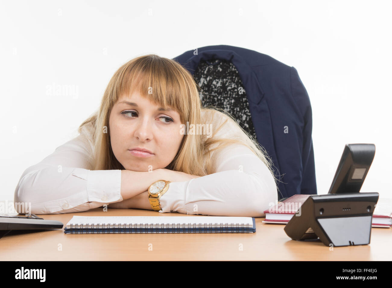 Office employee wearily and angrily looks at the phone rang Stock Photo
