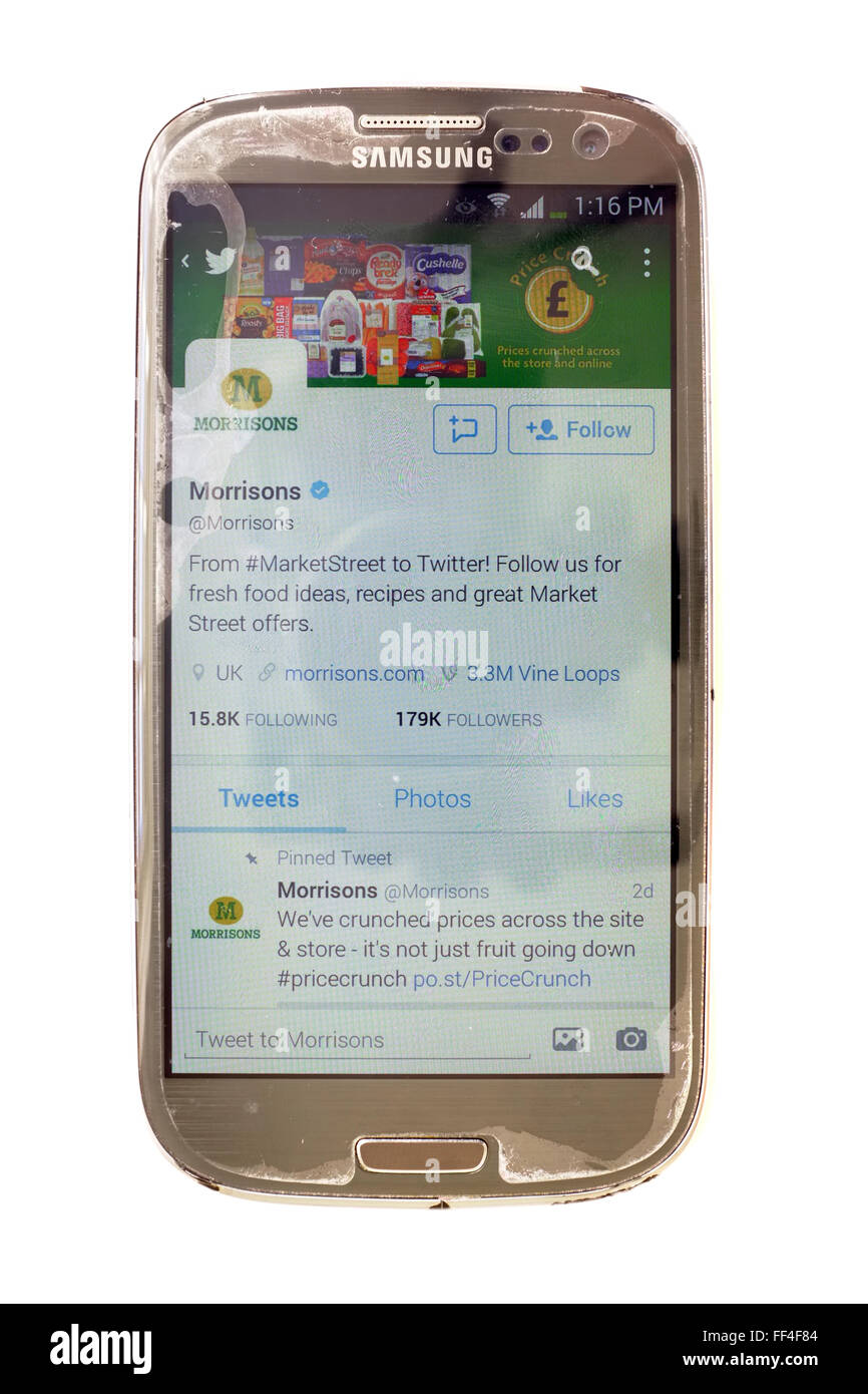The Morrisons Twitter account on a smartphone photographed against a white background. Stock Photo