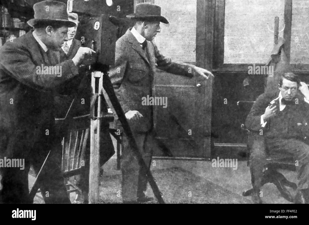 D.W.GRIFFITH  (1875-1948) American film director shooting 'The Escape'  with cameraman Billy Bitzer and actor Henry Walthal in 1913 Stock Photo