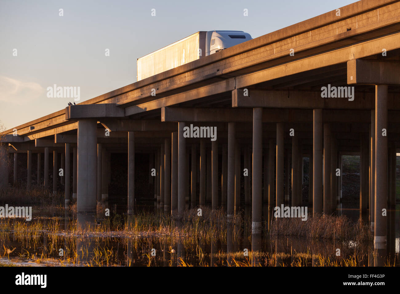 trucks on an elevated country highway California Stock Photo