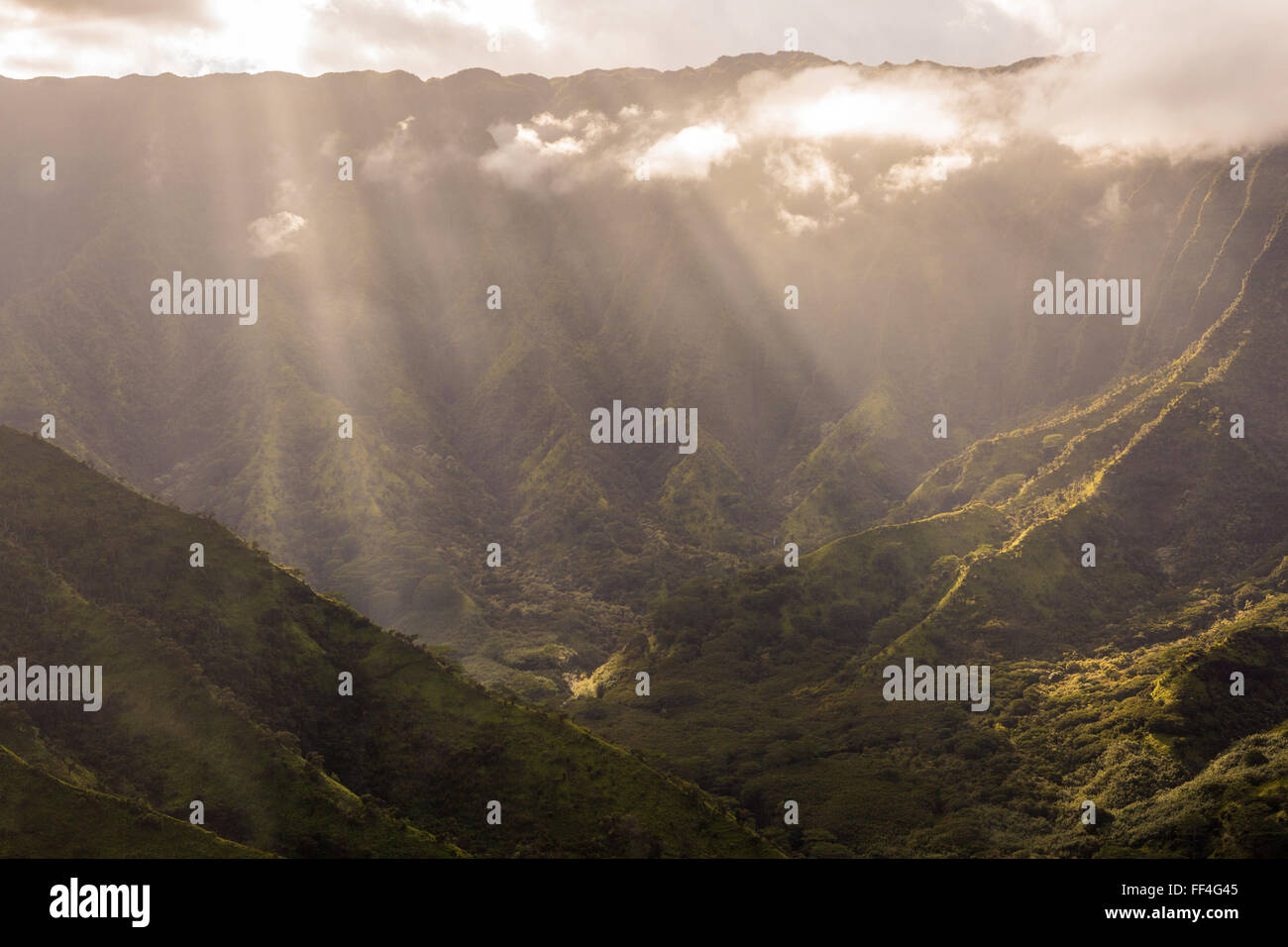 Sunlight through the clouds in Kauai valleys Stock Photo