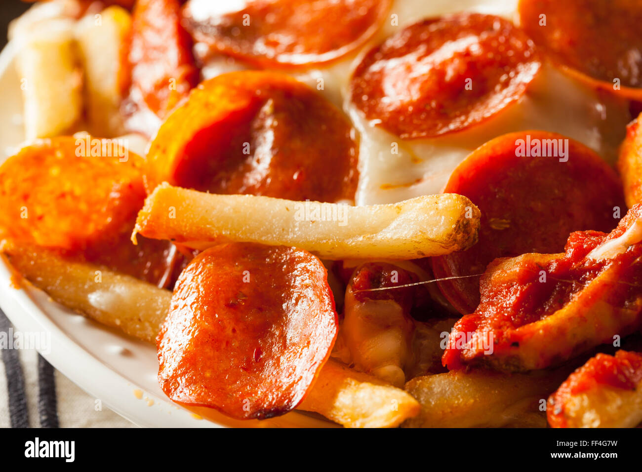Homemade Pepperoni and Cheese PIzza French Fries with Sauce Stock Photo
