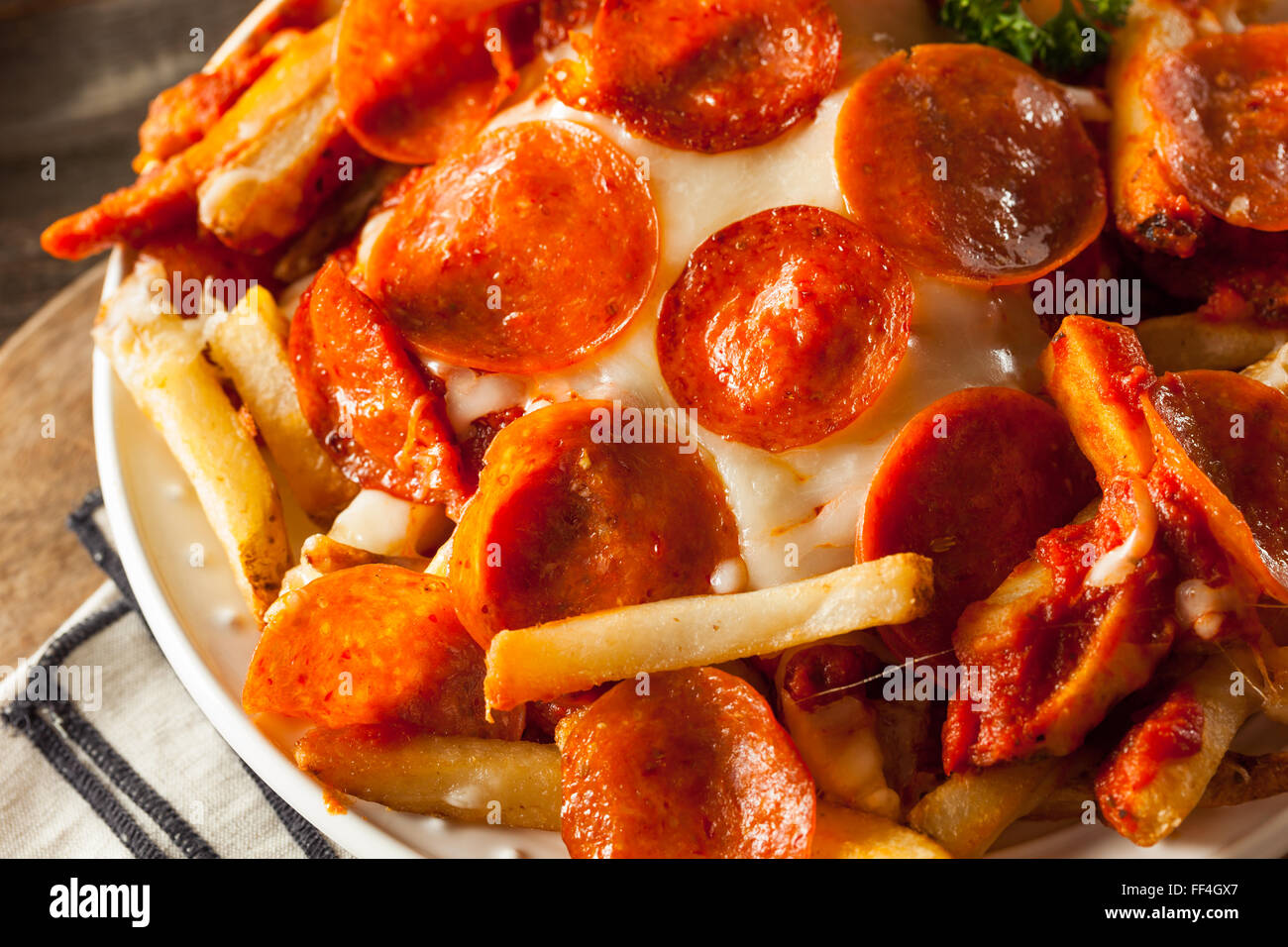 Homemade Pepperoni and Cheese PIzza French Fries with Sauce Stock Photo