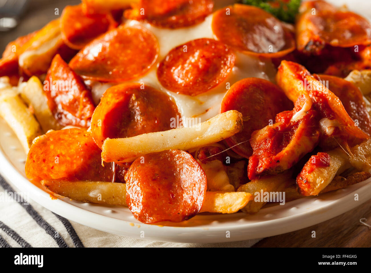 Homemade Pepperoni and Cheese PIzza French Fries with Sauce Stock Photo