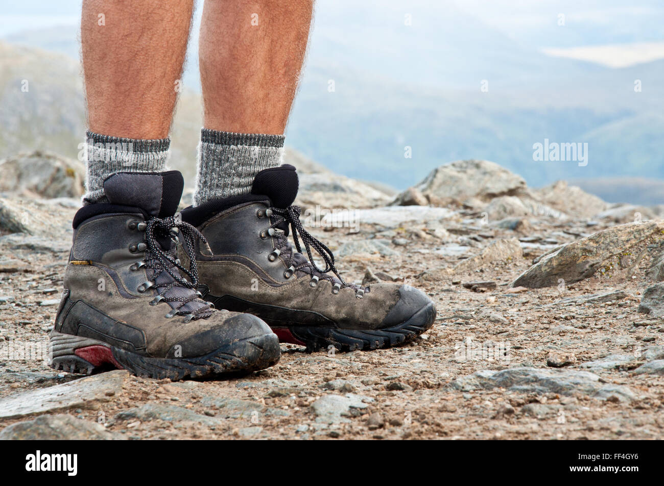Hiking shoes on the summit from hike walk in Scotland with mountain in the background Stock Photo