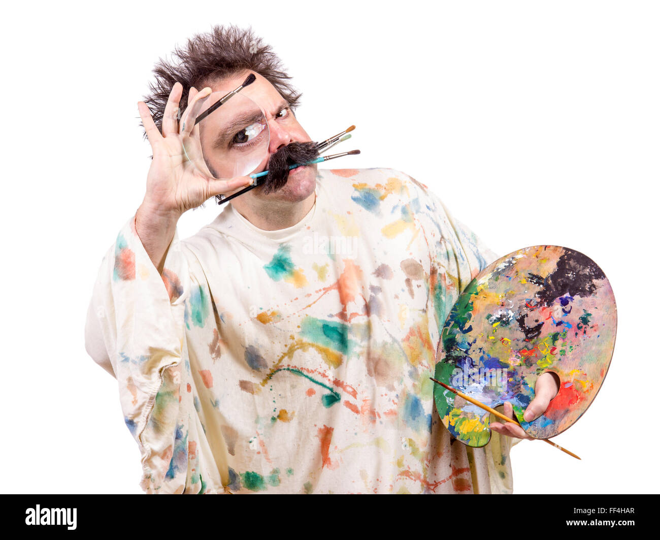 artistic painter looks through a magnifying glass Stock Photo