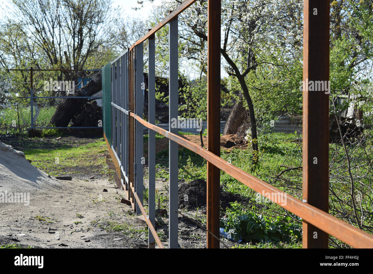 The steel frame of the new fence. The construction of the fence in the