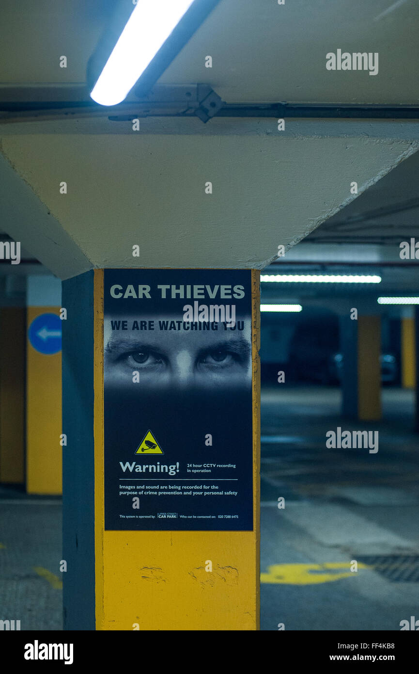 Warning to Car Thieves poster in underground car park, London, UK Stock Photo