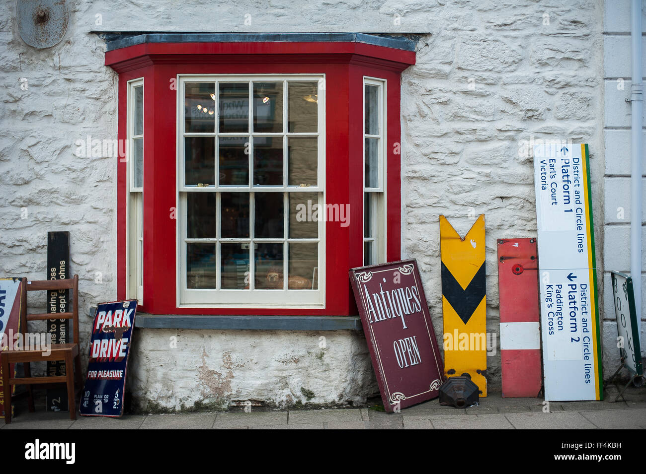Old signs for sale outside antiques shop, Newport, Pembrokeshire, Wales