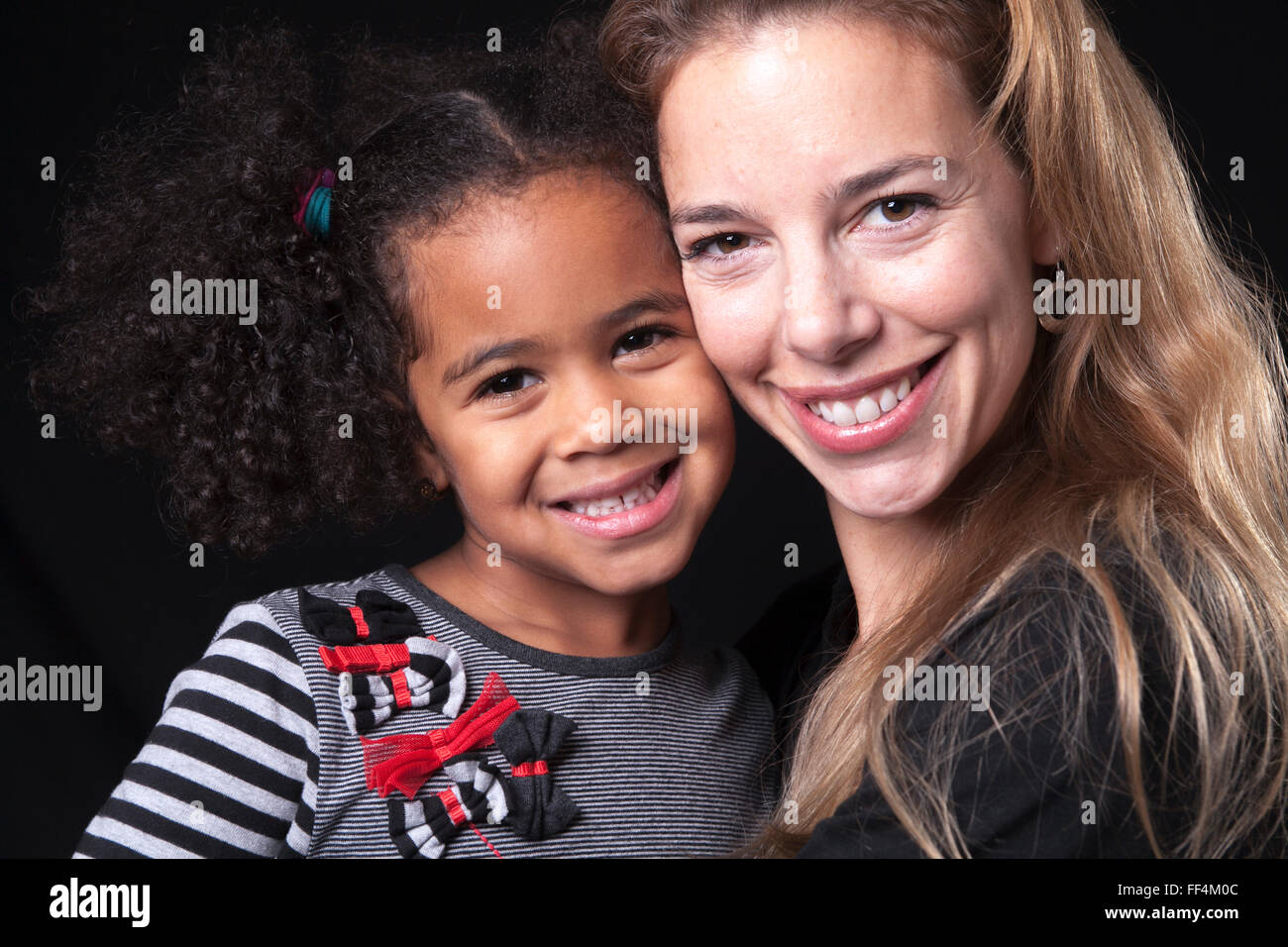 family posing on a black background studio Stock Photo