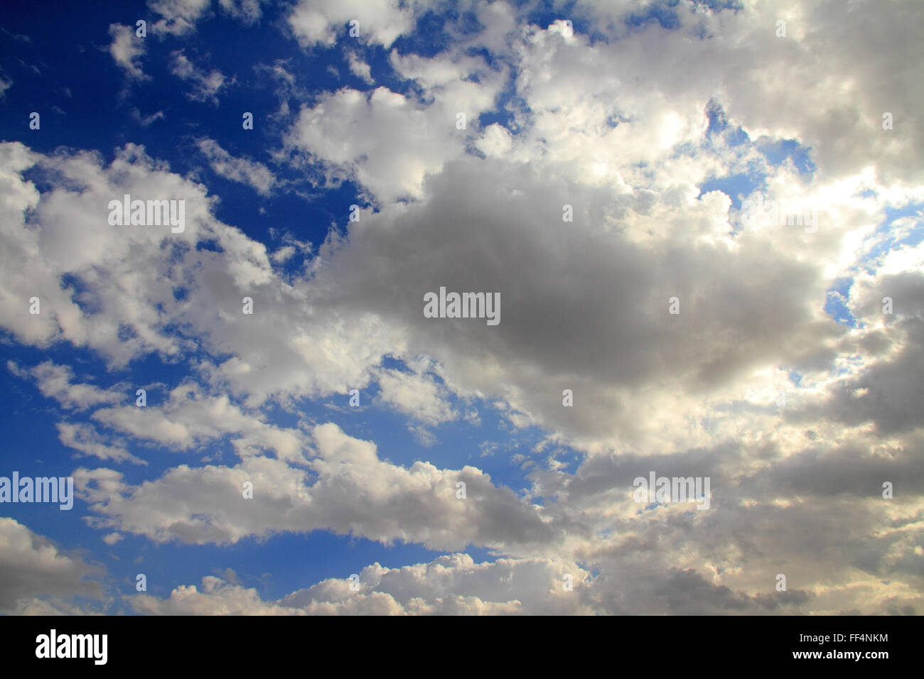 Puffy White Clouds With Dark Blue Sky Stock Photo - Alamy