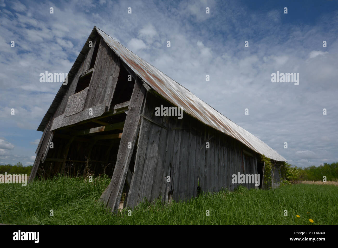 wide angle shot of an old wood long barn in summertime Stock Photo