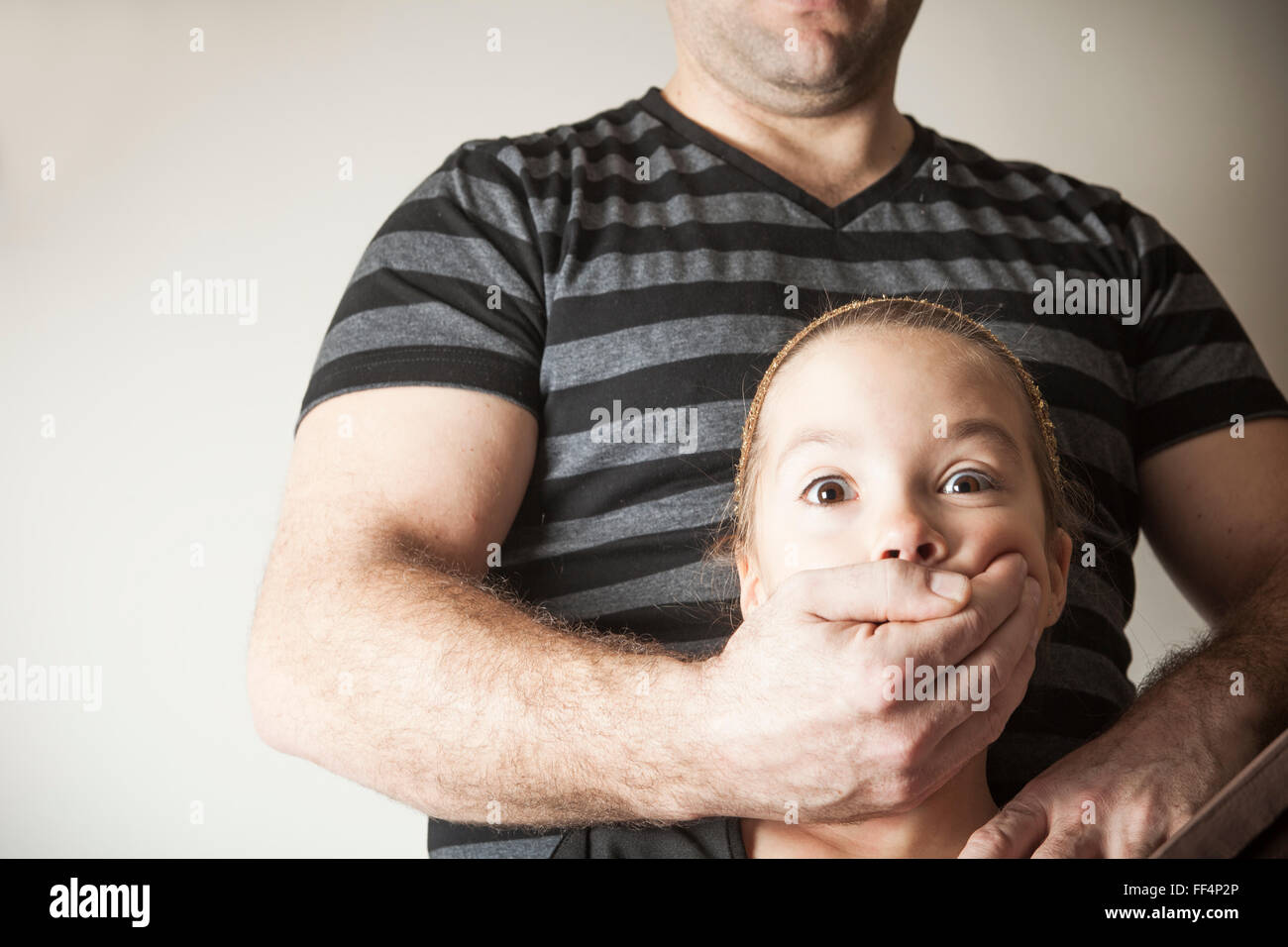 father abused his young daughter at home Stock Photo