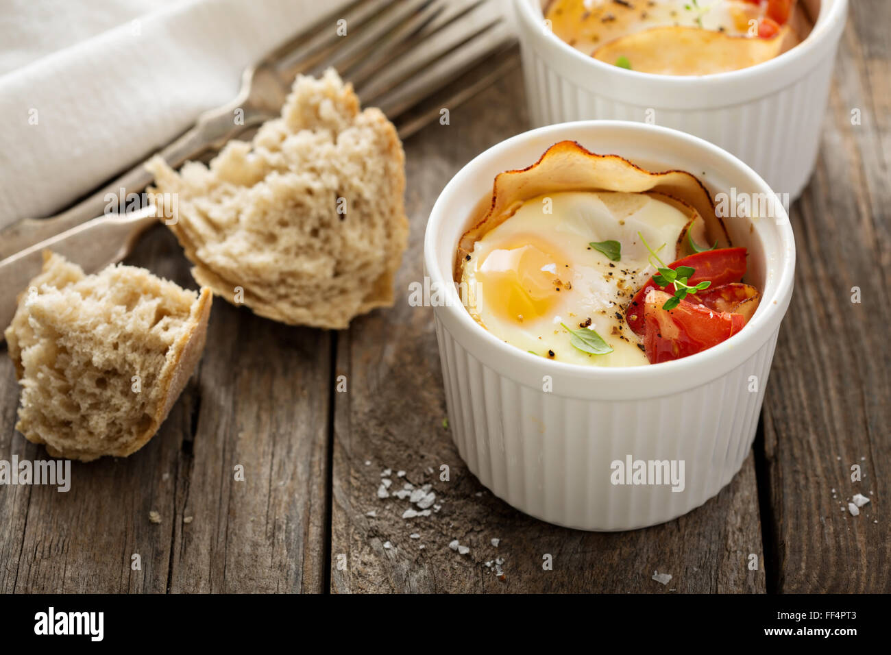 Baked eggs in small ramekin Stock Photo Alamy