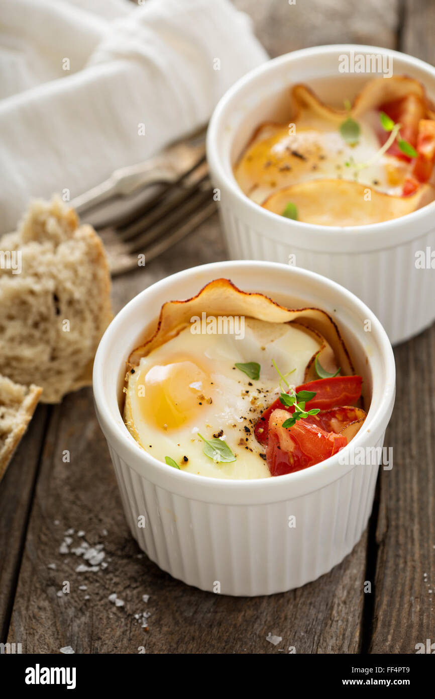 Baked eggs in small ramekin Stock Photo Alamy