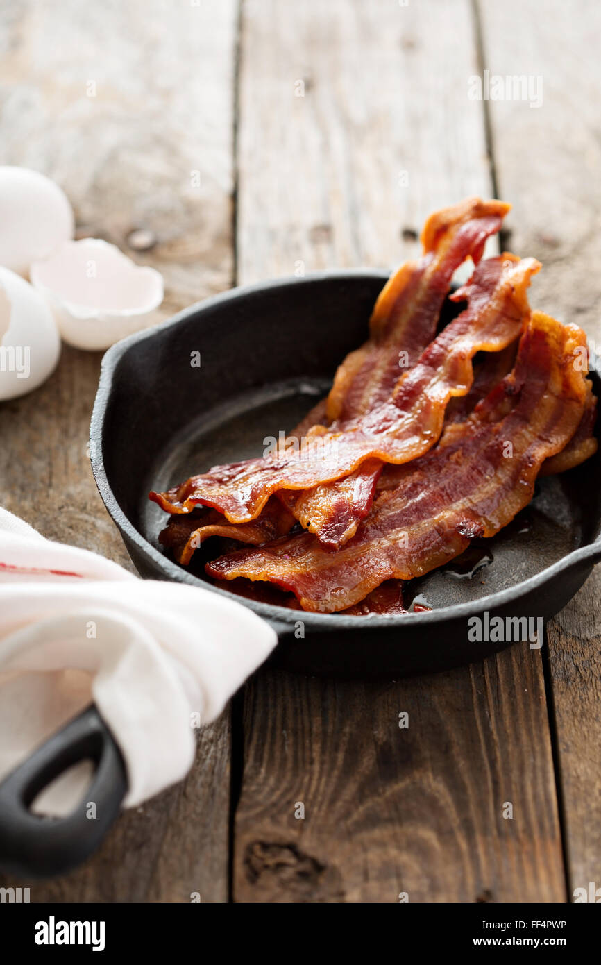 Sizzling hot bacon in a cast iron skillet Stock Photo Alamy