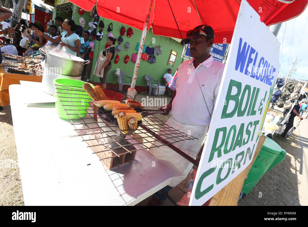 A food vendor cooks roast corn during the Parade of Bands in the Queen