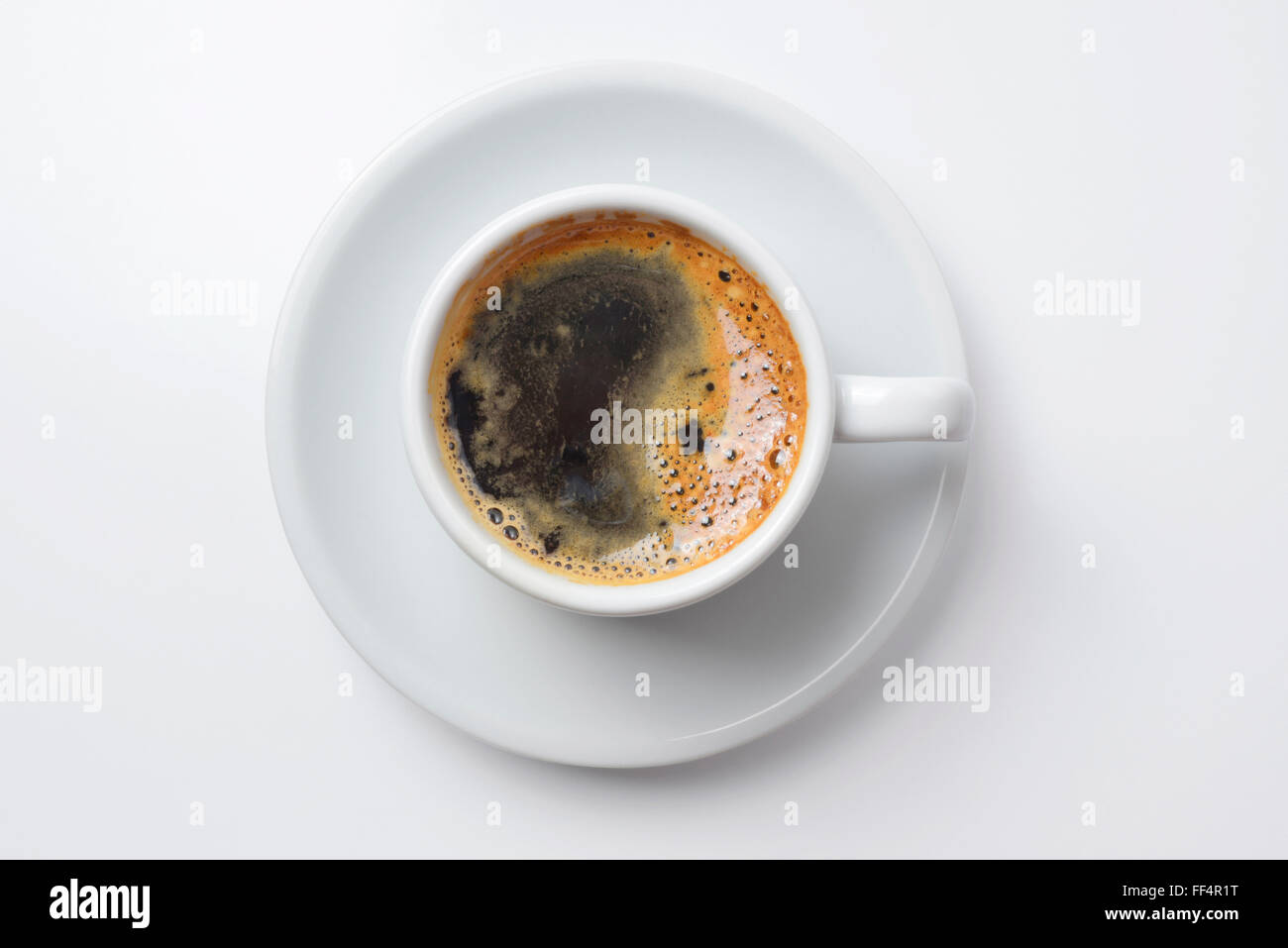 Single cup of coffee top view with plate, empty white background. Clipping path included, so you can easily copy and paste Stock Photo