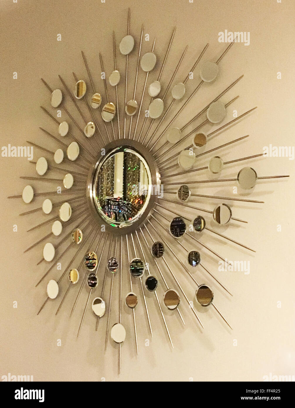 My aunt and uncle had a decorative mirror hanging on their dining room wall. Stock Photo