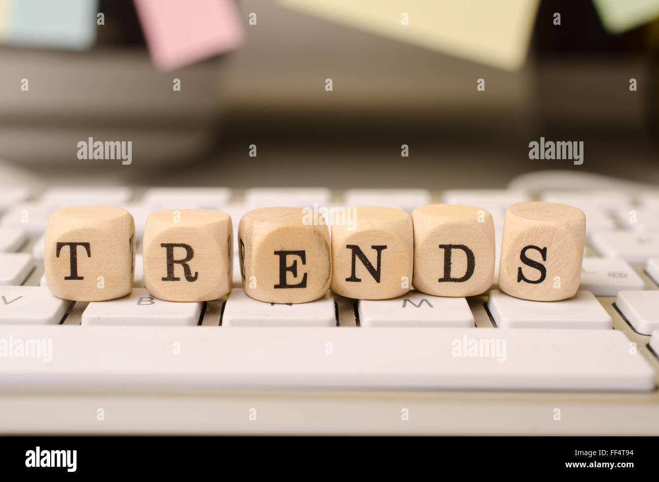 Wooden dices on a keyboard with the word trends Stock Photo