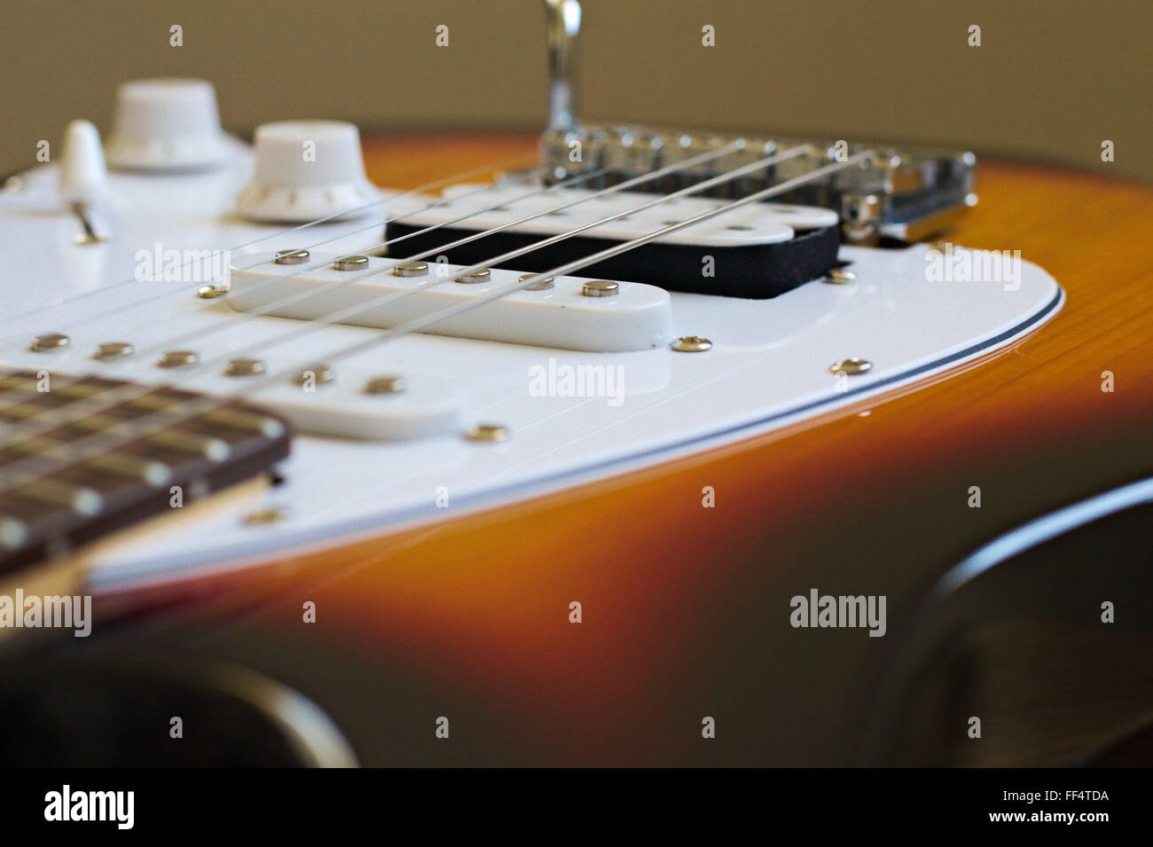 Looking over the bridge and scratchplate of an electric guitar. Stock Photo