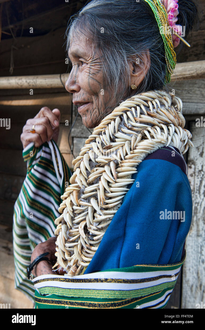 A Muun Chin woman with face tattoos and deer tooth necklace, Mindat, Myanmar. Stock Photo