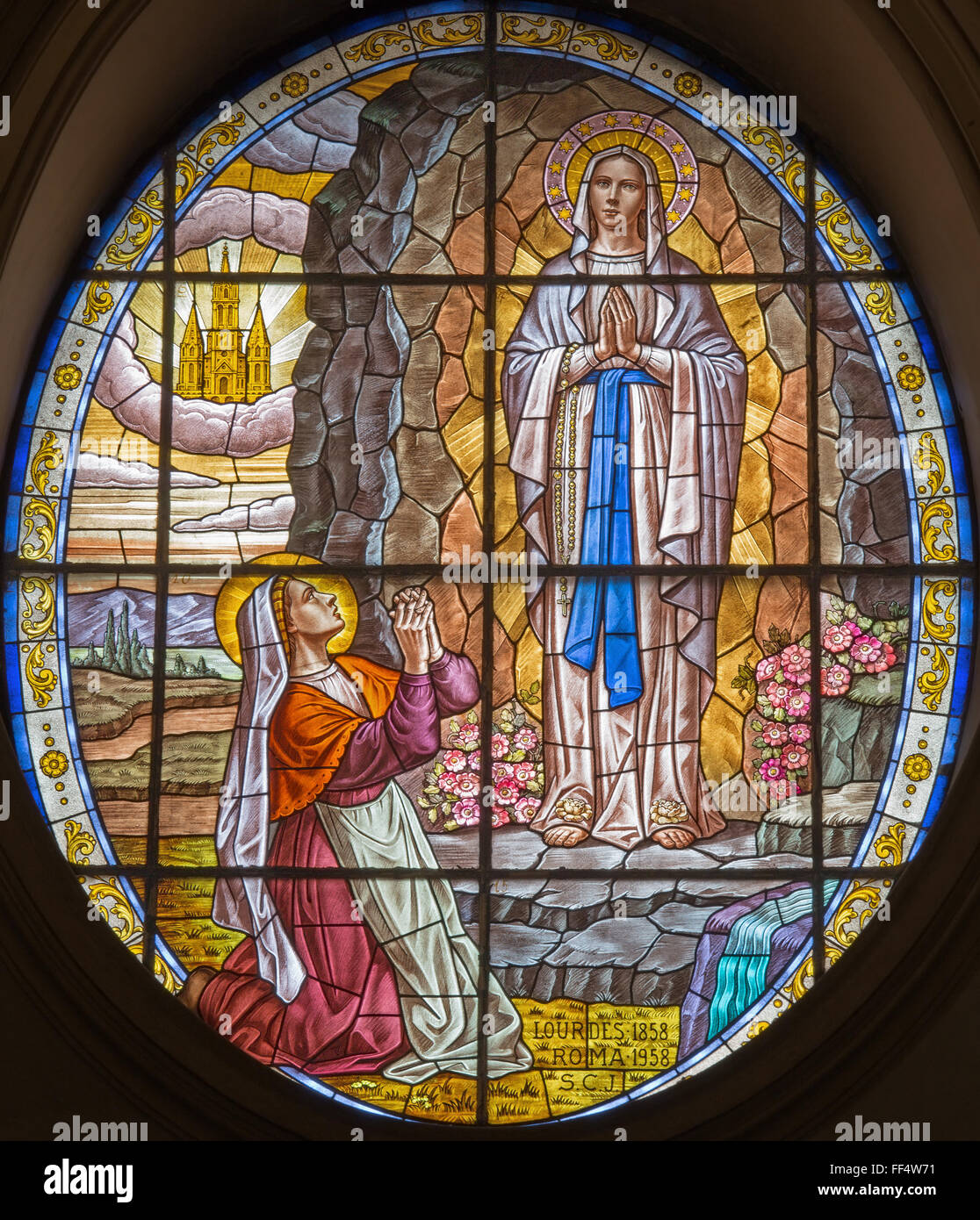 ROME, ITALY - 2015: The stained-glass of Virgin Mary of Lourdens in church Chiesa di Santa Maria Annunziata, by artist S. C. J. Stock Photo
