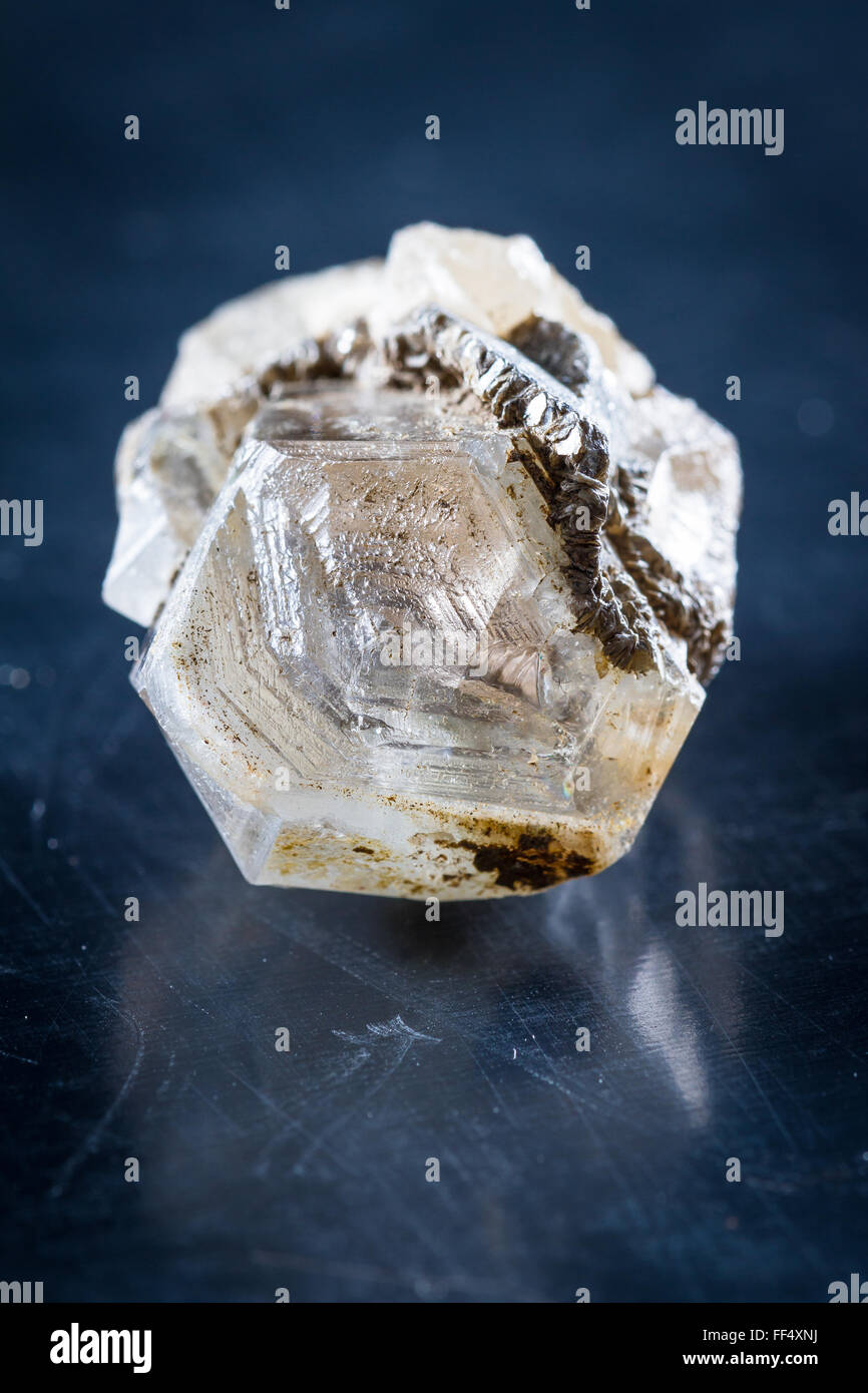 close up of a small quartz crystal with a and of silver growing around