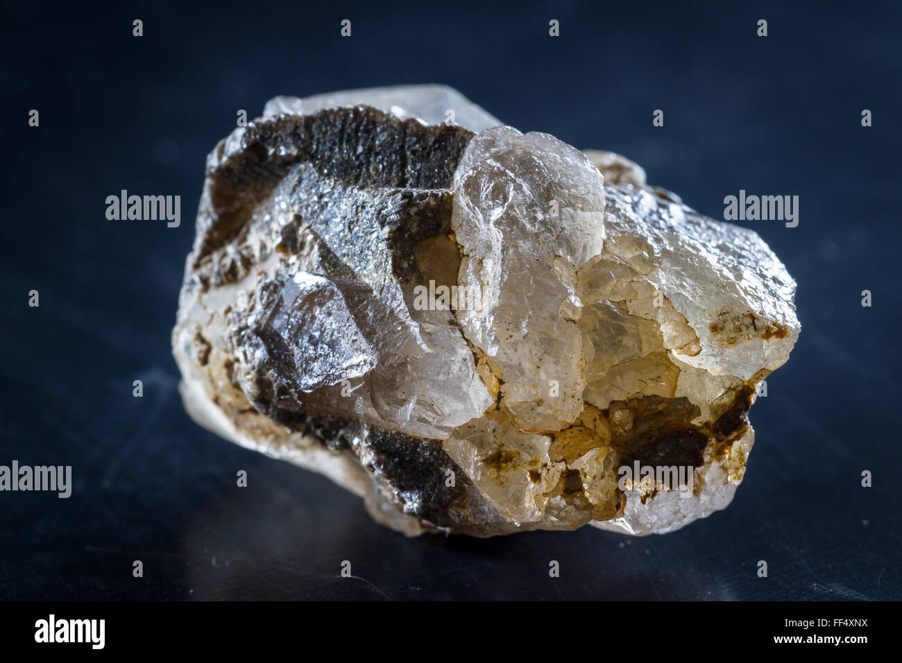 close up of a small quartz crystal with a and of silver growing around