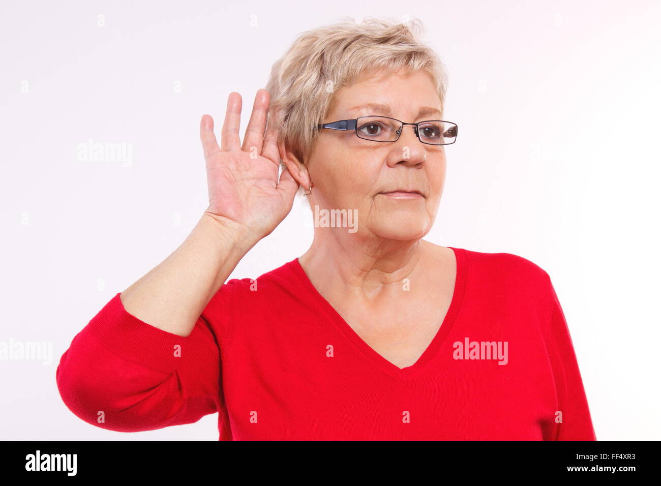 Elderly senior woman placing hand on ear, difficulty in hearing in old