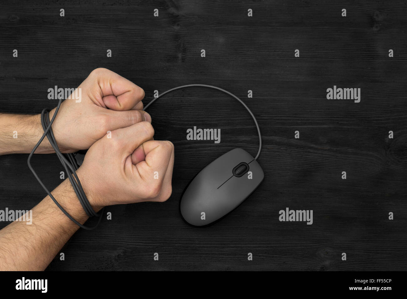 Bound wrist by computer mouse cable, on black background Stock Photo ...