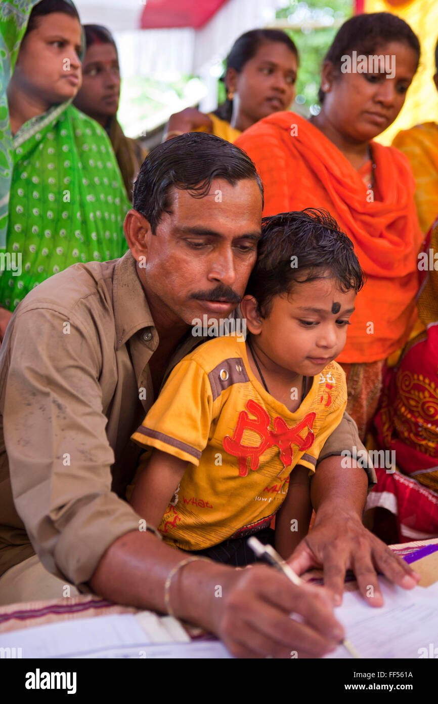 Families from the Dobhanda Nagar slum in Cuttack get legal advice and birth certificates from the Urban Law centre run by the organisation CLAP, Committee for Legal Aid to Poor, helps provide legal aid to the poorer communities in the Orissa district of India. Stock Photo