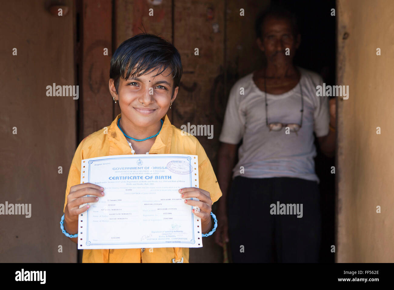 A young girl from the Dobhanda Nagar slum in Cuttack gets her birth certificates from the Urban Law centre run by the organisation CLAP. Committee for Legal Aid to Poor (CLAP) helps provide legal aid to the poorer communities in the Orissa district of India. Stock Photo