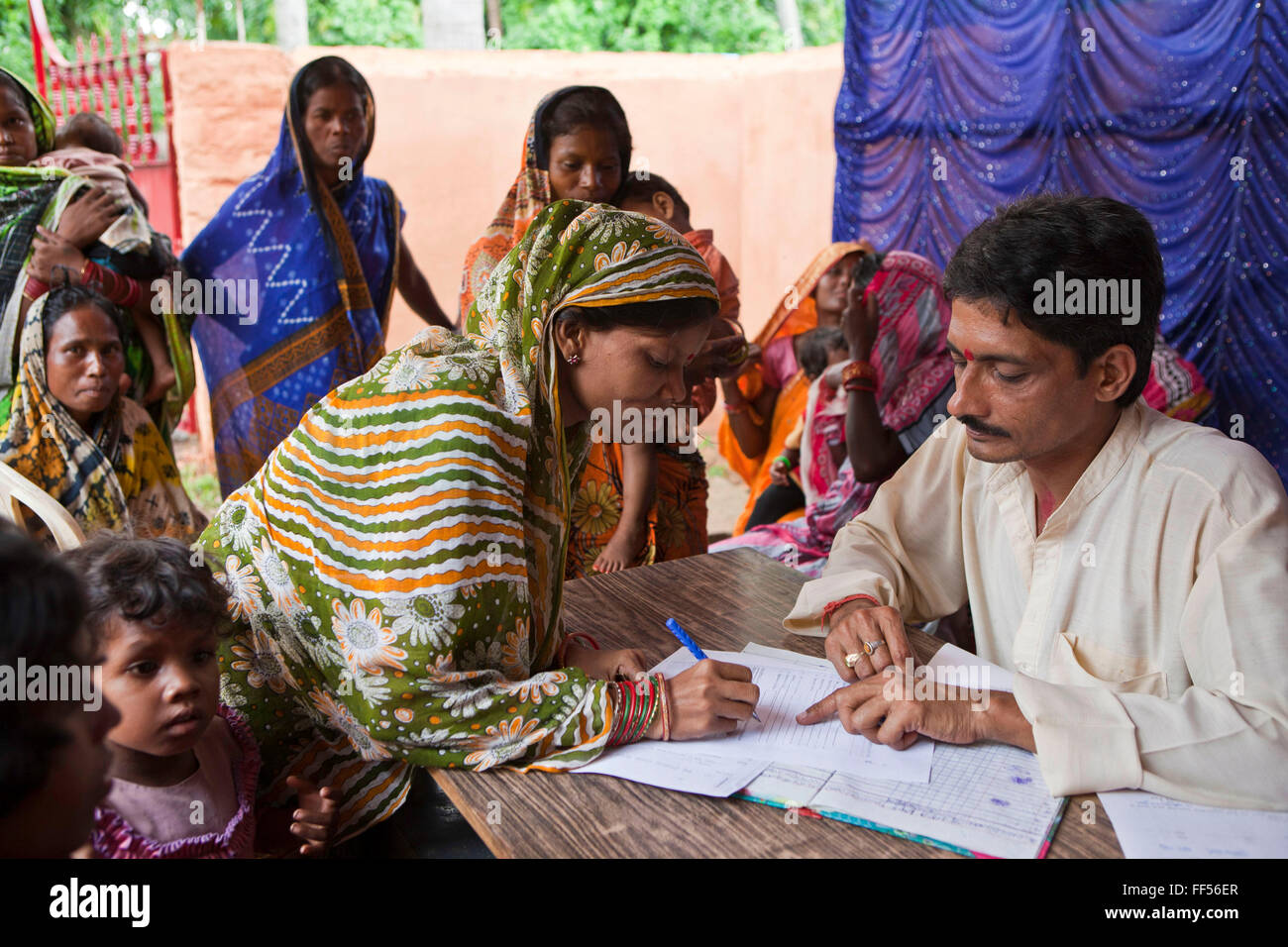 Families from a rural slum in the Orissa district of India get legal advice and birth certificates from a Legal Aid Clinic run by the organisation CLAP. Committee for Legal Aid to Poor (CLAP) is a non-profit organisation helping to provide legal aid to the poorer communities in the Orissa district of India. Stock Photo