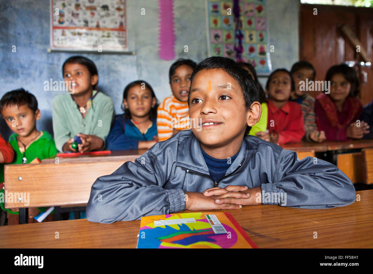 A boy in a lesson at the Alternate Learning Hub, Subhai, Himalayas, India. The school is organized and funded by the Pragya charity.  Pragya is a non-profit organization providing education and information services in high altitude areas in the Himalayas. Stock Photo