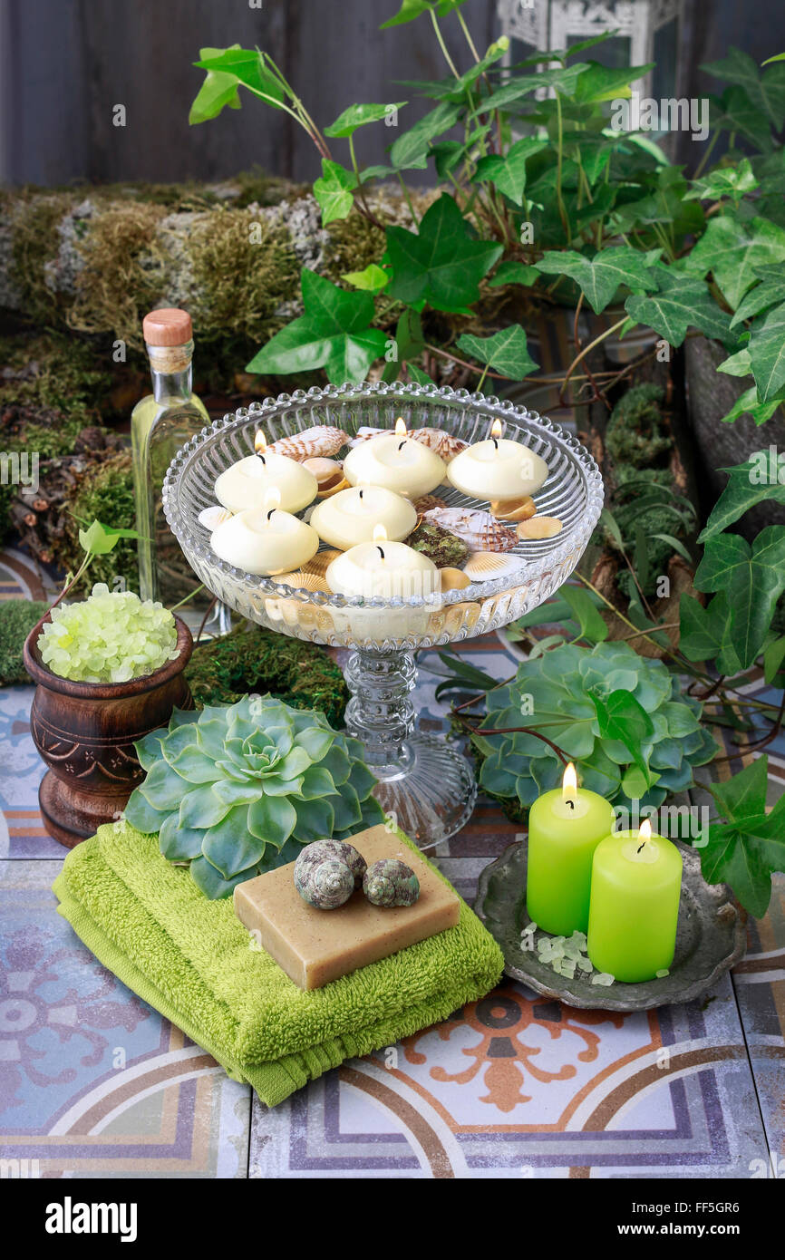 Floating candles in crystal bowl. Beautiful garden decoration Stock
