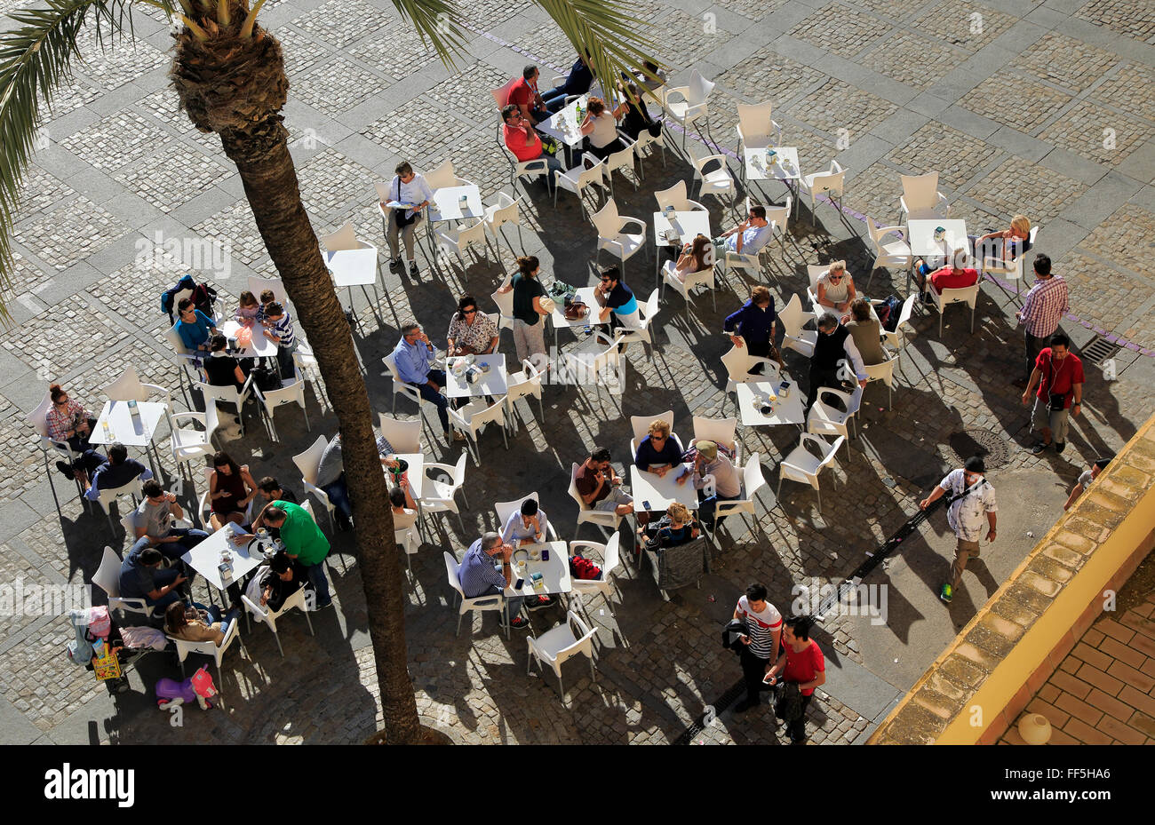 Looking form overhead down on people at restaurant tables in Plaza de la Catedral, Cadiz, Spain Stock Photo