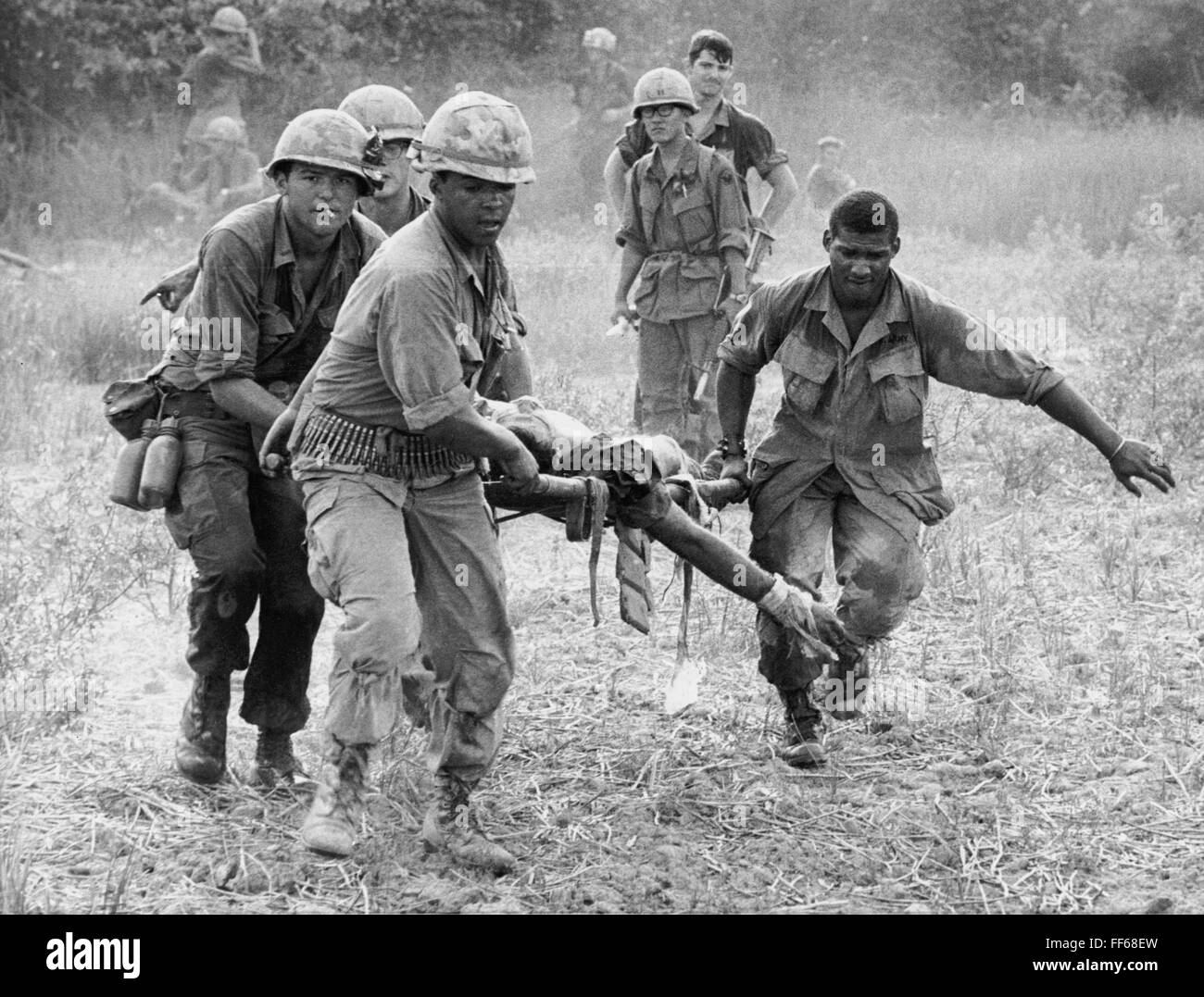 VIETNAM WAR, 1969. /nAn American soldier, wounded by an exploding land mine, carried to a helicopter by his comrades, 1969. Stock Photo