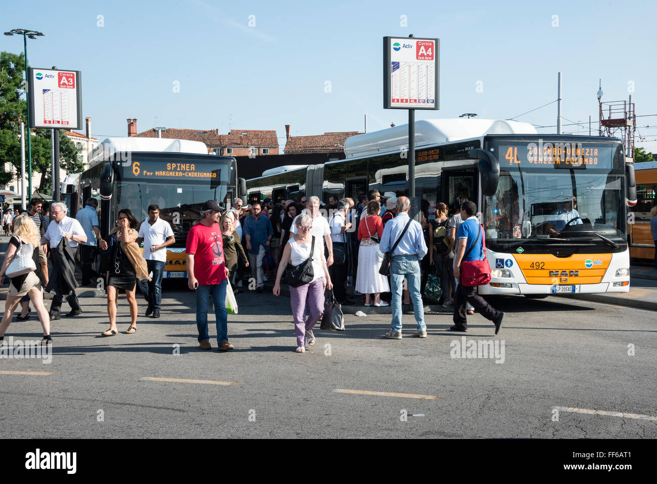 Workers heading to their workplaces at the main Venice bus terminal at Piazzale Roma next to the Canale Grande (Grand Canal) in Stock Photo