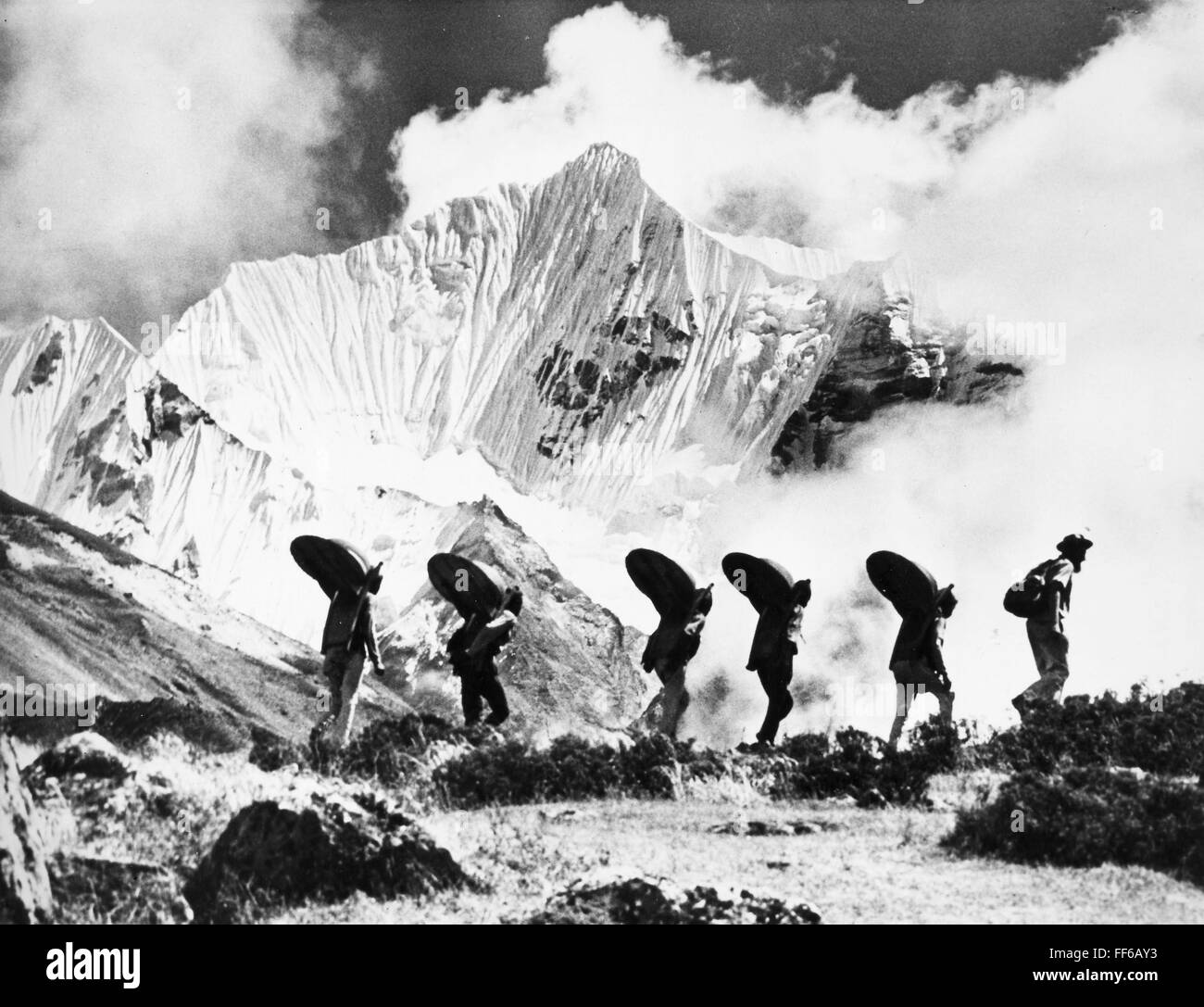 HIMALAYAN SURVEY, 1958. /nSwiss geologist Toni Hagen leading porters on a 1958 surveying expedition on behalf of the government of Nepal, near the Gangja La in the Langtang Valley in the Himalayan ranges of Nepal. Stock Photo