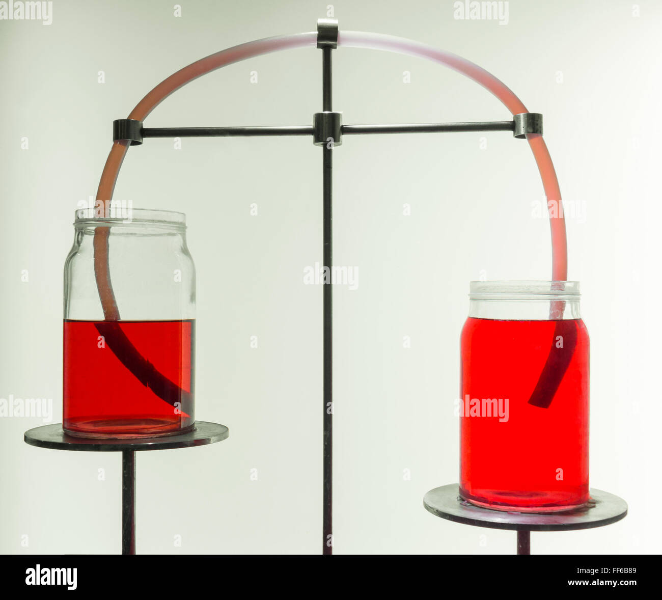 Communicating vessels of liquid in lab Stock Photo Alamy