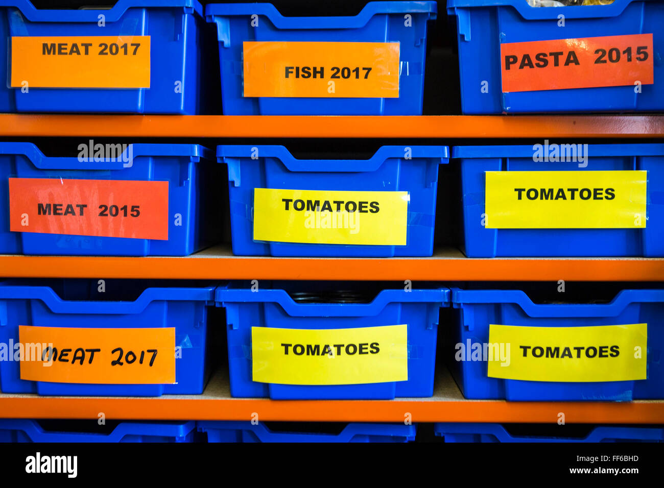 Organized food storage in plastic boxes on shelves in the Trussell Trust foodbank distribution